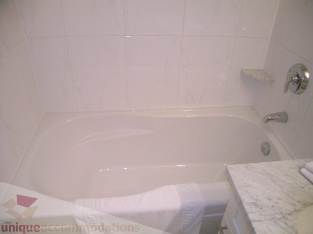 Bathroom with white tile, marble countertop, and towel rack. - 3802 - 1189 Melville Street, Vancouver Downtown
