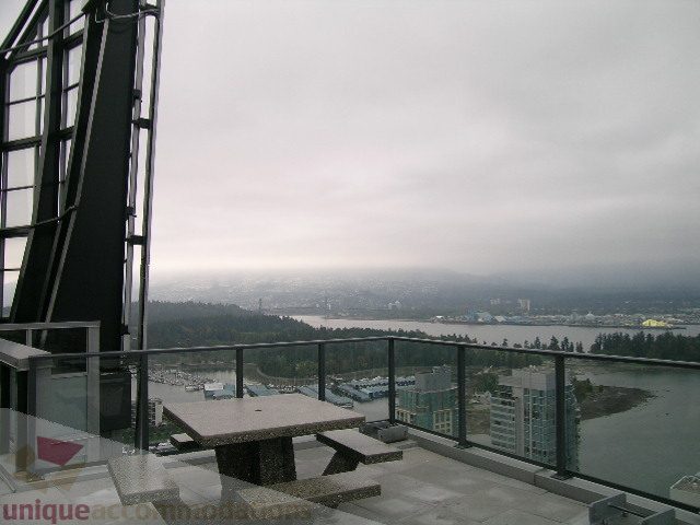 Furnished living room with city view and modern furnishings. - 3802 - 1189 Melville Street, Vancouver Downtown