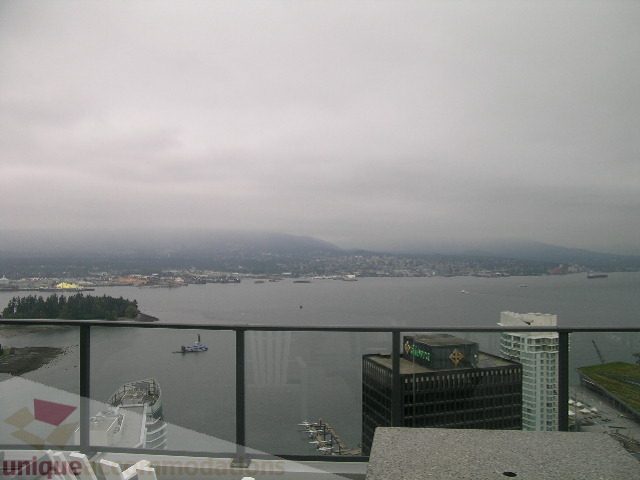 Furnished living room with a stunning city view and balcony access. - 3802 - 1189 Melville Street, Vancouver Downtown
