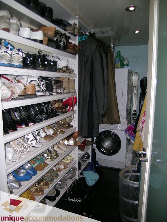 Spacious walk-in closet with shelves full of shoes and hanging coats, perfect for a 1-bedroom condo. - 705 - 1500 Howe street, Vancouver Downtown