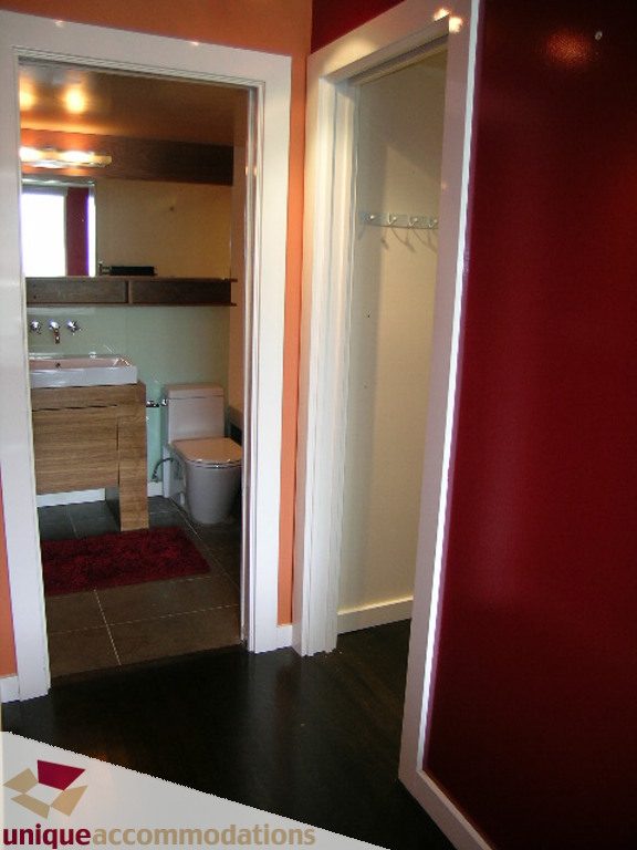 Bright bathroom with wooden countertops and red walls, showcasing a cozy and modern design. - 705 - 1500 Howe street, Vancouver Downtown