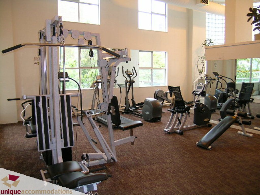 Bright gym with cardio equipment and natural light from large windows. - 705 - 1500 Howe street, Vancouver Downtown