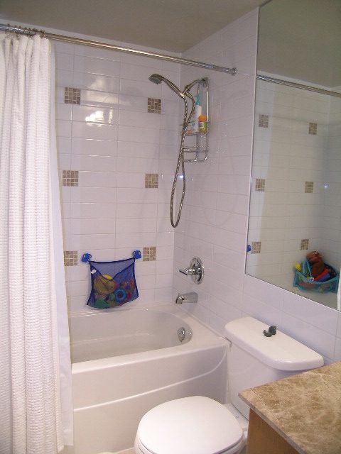Bright bathroom with a bathtub, shower, and countertop. - 315 - 4078 Knight Street, Vancouver West Side