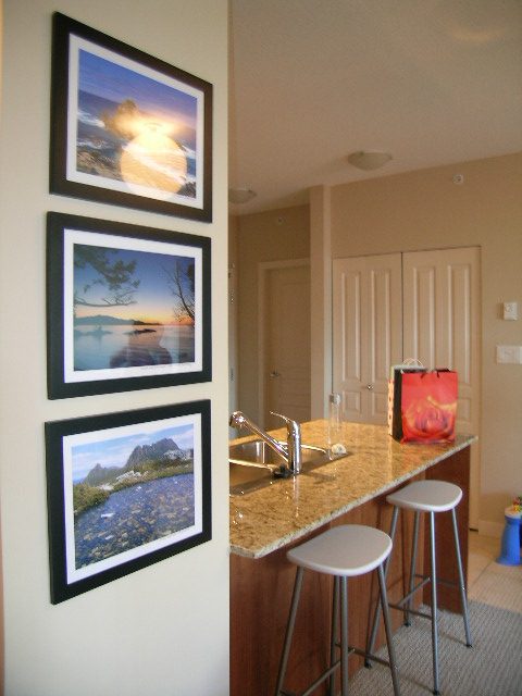 Bright kitchen with granite countertops, modern bar stools, and framed nature prints on the wall. - 315 - 4078 Knight Street, Vancouver West Side