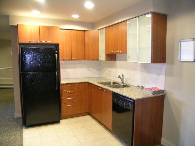 Bright kitchen with granite countertops, wooden cabinets, and stainless steel appliances. - 315 - 4078 Knight Street, Vancouver West Side