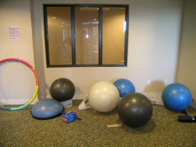 Fitness room with exercise balls and hula hoop, carpeted floor. - 315 - 4078 Knight Street, Vancouver West Side