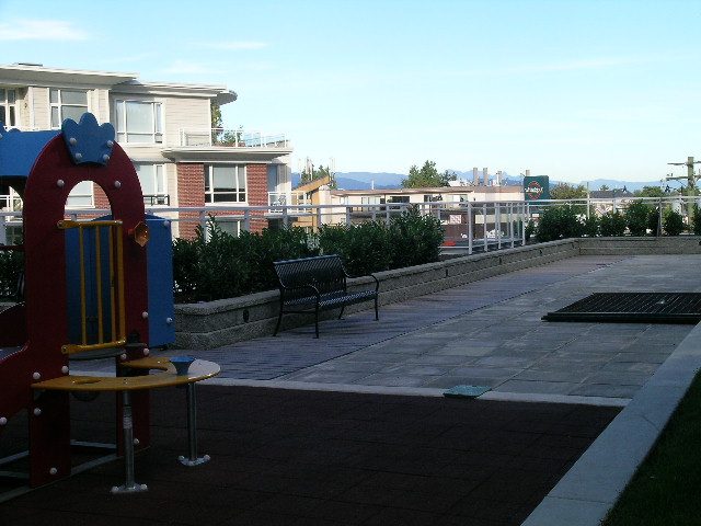 Open rooftop patio with playground equipment and city views. - 315 - 4078 Knight Street, Vancouver West Side