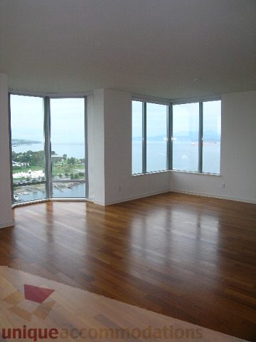 Bright living room with hardwood floors and a stunning city view. - 2401 - 1005 Beach Avenue, Vancouver Downtown