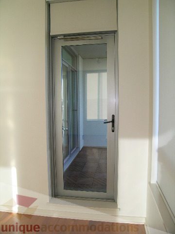 Bright balcony with sliding glass doors leading to tiled patio. - 2401 - 1005 Beach Avenue, Vancouver Downtown