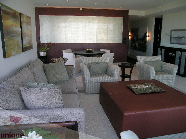 Furnished living room with plush couch, patterned armchairs, and a large ottoman. - 4303 - 1408 Strathmore Mews, Vancouver Downtown