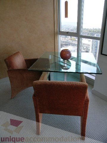 Dining area with modern chairs, glass table, and city view. - 4303 - 1408 Strathmore Mews, Vancouver Downtown