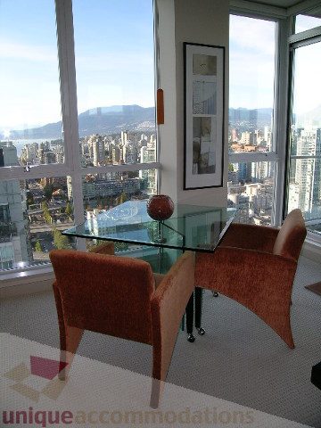 Bright dining area with city view, modern furniture, and large windows. - 4303 - 1408 Strathmore Mews, Vancouver Downtown