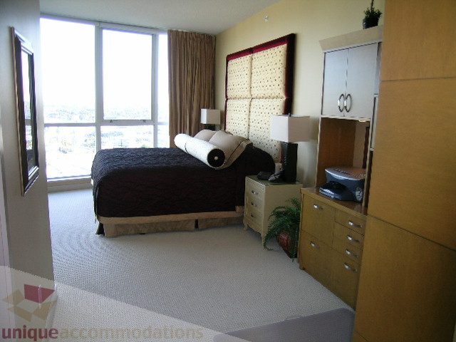 Spacious 3-bedroom condo with large windows offering a city view, modern furnishings, and ample storage.