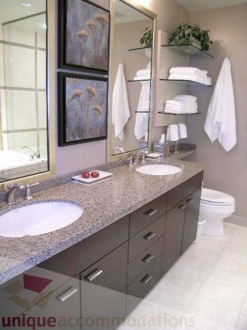 Furnished bathroom with granite countertops and dark cabinets. - 4303 - 1408 Strathmore Mews, Vancouver Downtown