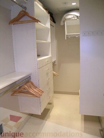 Furnished walk-in closet with white shelves and hangers. - 4303 - 1408 Strathmore Mews, Vancouver Downtown