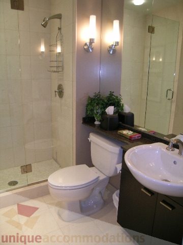 Bathroom with modern sink, toilet, and shower, clean and well-lit. - 4303 - 1408 Strathmore Mews, Vancouver Downtown