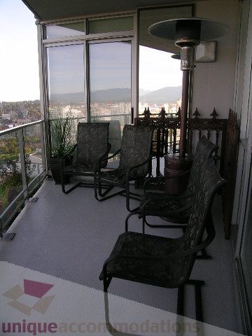 Furnished balcony with city view, patio heater, and outdoor furniture. - 4303 - 1408 Strathmore Mews, Vancouver Downtown