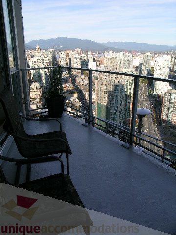 Furnished balcony with city view and modern furniture. - 4303 - 1408 Strathmore Mews, Vancouver Downtown