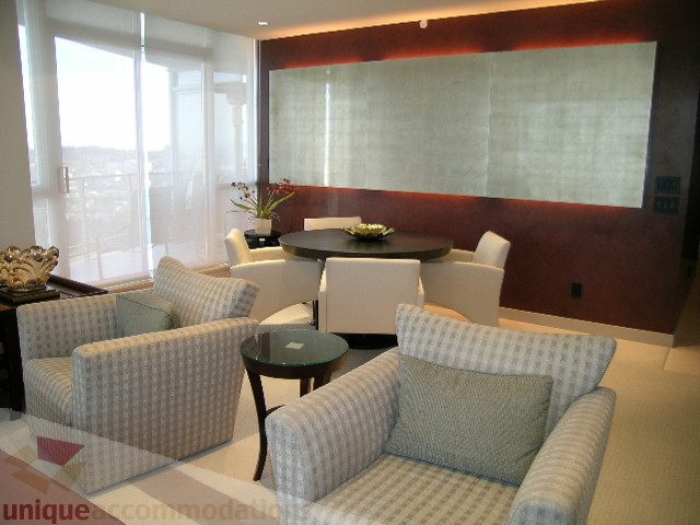 Bright living room with checkered furniture and city view. - 4303 - 1408 Strathmore Mews, Vancouver Downtown