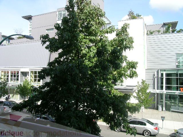 Furnished living room with modern furnishings and city view. - 208 - 428 West 8th Ave, Vancouver West Side