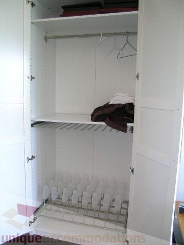 Bright and clean closet with hanging space and shelves, neatly organized. - 208 - 428 West 8th Ave, Vancouver West Side