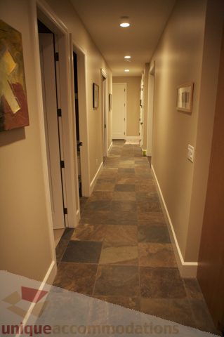 Framed artwork and tiled floor in hallway leading to bedrooms. - 3781 Bayridge Ave, West Vancouver