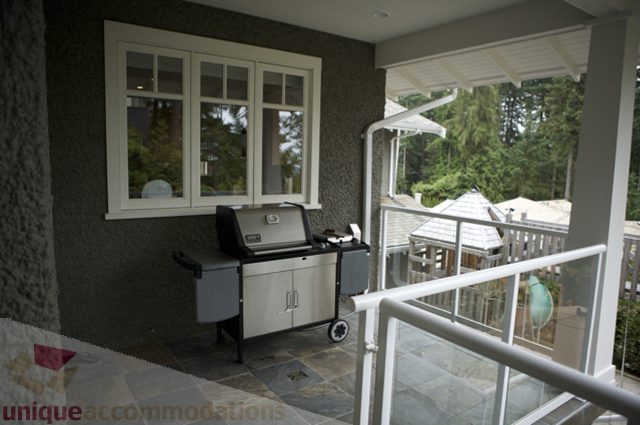 Furnished living room with glass railing and outdoor view. - 3781 Bayridge Ave, West Vancouver