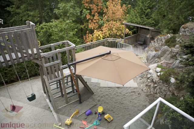 Furnished patio with swing set, umbrella, and rock garden. - 3781 Bayridge Ave, West Vancouver