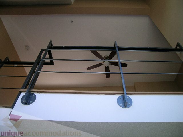 Bright kitchen with modern black railings and sleek white countertops. - 137 Alexander Street, Vancouver Downtown