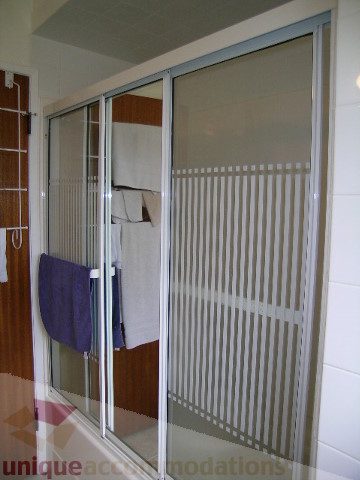 Furnished bathroom with frosted glass sliding doors and towel rack. - 4408 Arbutus Street, Vancouver West Side