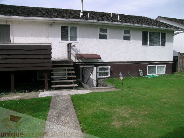 Furnished patio with steps leading to a deck and grassy area. - 4408 Arbutus Street, Vancouver West Side