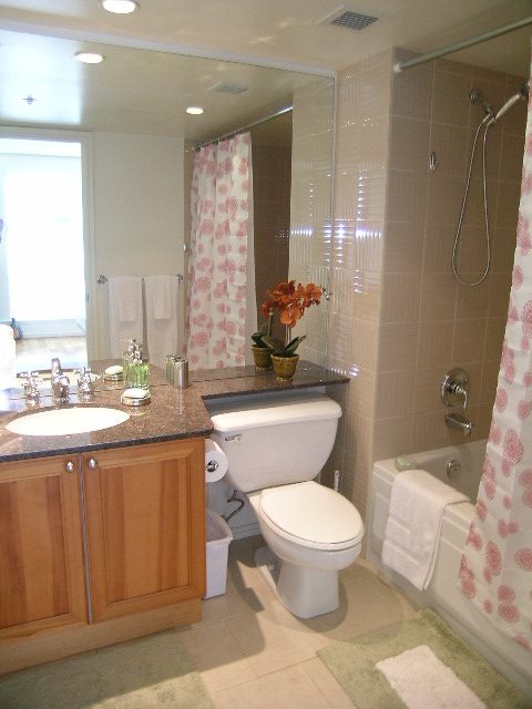 Bright bathroom with granite countertops, wooden cabinets, and a city view. - 1102 - 1723 Alberni Street, Vancouver Downtown
