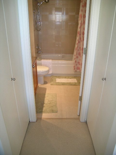 Bright bathroom with shower, bathtub, and beige carpet. - 1102 - 1723 Alberni Street, Vancouver Downtown