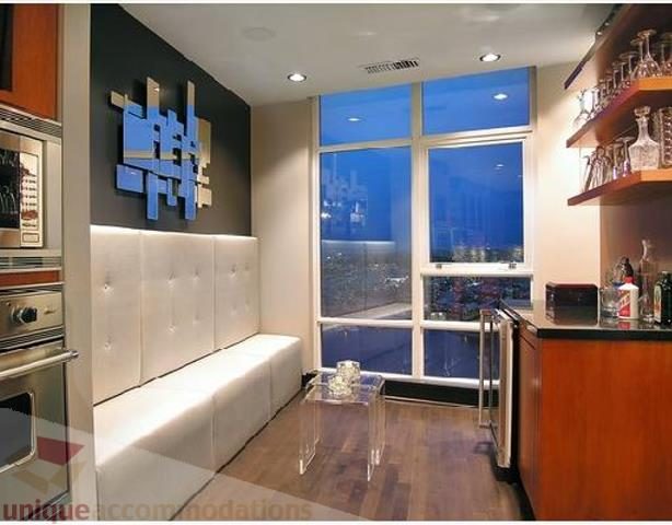 Bright kitchen with modern decor, hardwood floors, and a city view. - 3202 - 1483 Homer Street, Vancouver Downtown