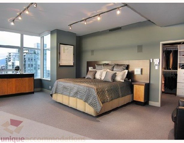 Furnished master bedroom with city view, modern lighting, and large closet. - 3202 - 1483 Homer Street, Vancouver Downtown