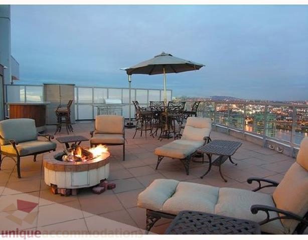 Furnished rooftop patio with lounge chairs, fire pit, and city view. - 3202 - 1483 Homer Street, Vancouver Downtown