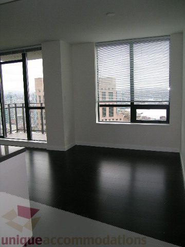 Spacious living room with hardwood floors and city view. - 2804-788 Richards Street, Vancouver Downtown