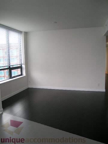 Bright living room with hardwood floors and large window view. - 2804-788 Richards Street, Vancouver Downtown