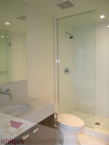 Bathroom with glass shower and modern sink setup. - 2804-788 Richards Street, Vancouver Downtown