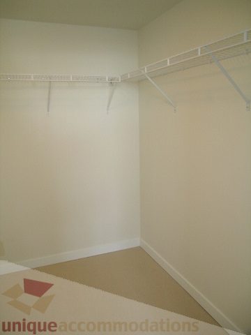 Empty closet with white shelves and beige carpet. - 2804-788 Richards Street, Vancouver Downtown