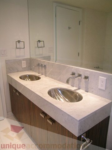 Modern bathroom with marble countertops and a sleek sink design. - 2804-788 Richards Street, Vancouver Downtown