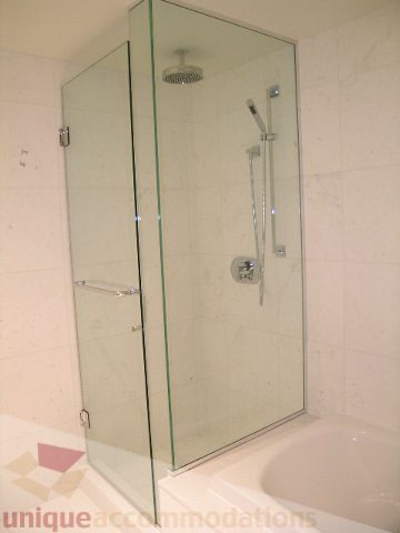 Furnished bathroom with glass shower and bathtub. - 2804-788 Richards Street, Vancouver Downtown