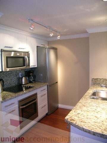 Bright kitchen with granite countertops, stainless steel appliances, and hardwood floors. - 1205 - 1331 West Georgia Street, Vancouver Downtown