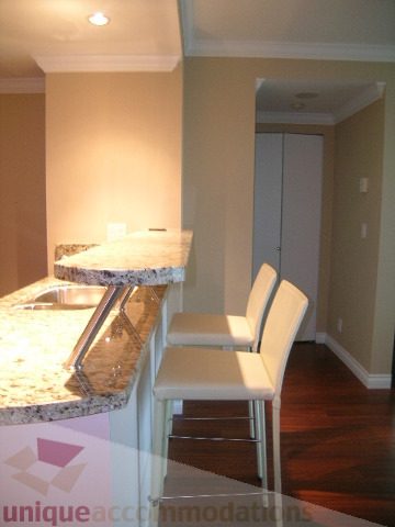 Spacious kitchen with granite countertops and hardwood floors, perfect for cooking and entertaining.