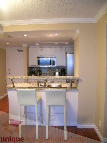 Bright kitchen with granite countertops, hardwood floors, and a modern layout. - 1205 - 1331 West Georgia Street, Vancouver Downtown