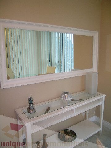 Spacious bathroom with large mirror, glass countertop, and city view. - 1205 - 1331 West Georgia Street, Vancouver Downtown