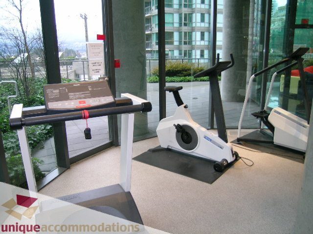 Spacious living room with modern furniture and a city view. - 1205 - 1331 West Georgia Street, Vancouver Downtown