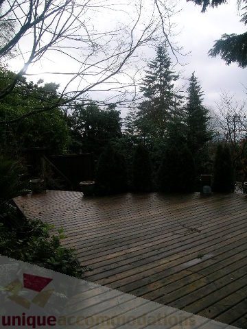 Furnished 3-bedroom suite with wooden deck and forest view. - 250 Rockland Road West, North Vancouver