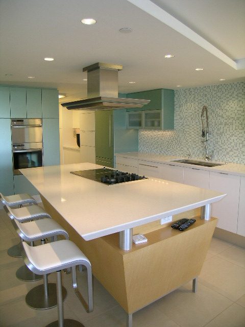 Bright kitchen with modern white countertops and stainless steel appliances. - 708 - 27 Alexander Street, Vancouver Downtown