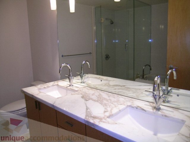 Bathroom with marble countertop and modern fixtures. - 604 - 1205 West Hastings Street, Vancouver Downtown